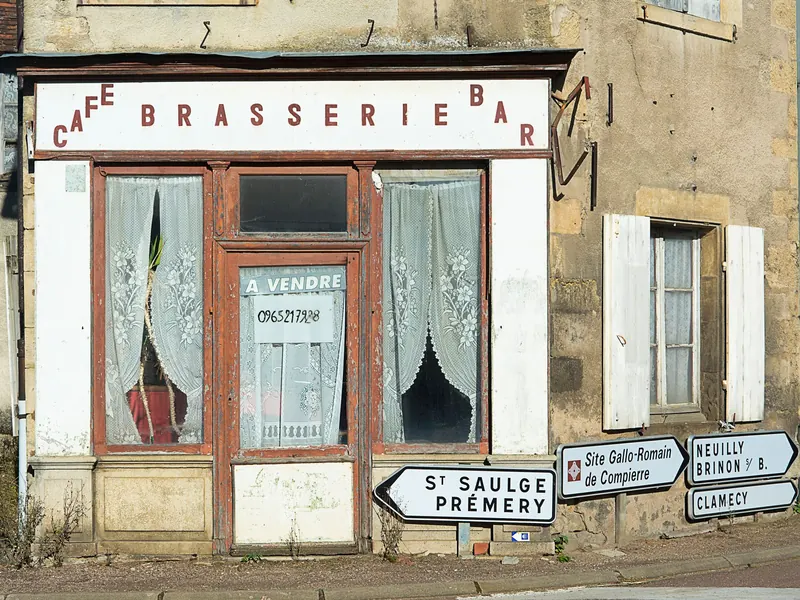 An old shopfront with a faded sign above the door