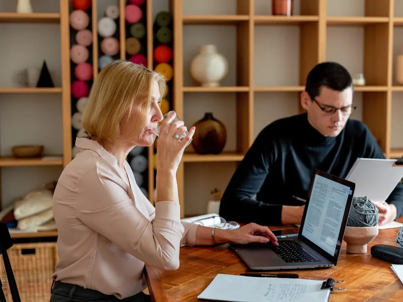 Colleagues at a meeting table with glasses of water